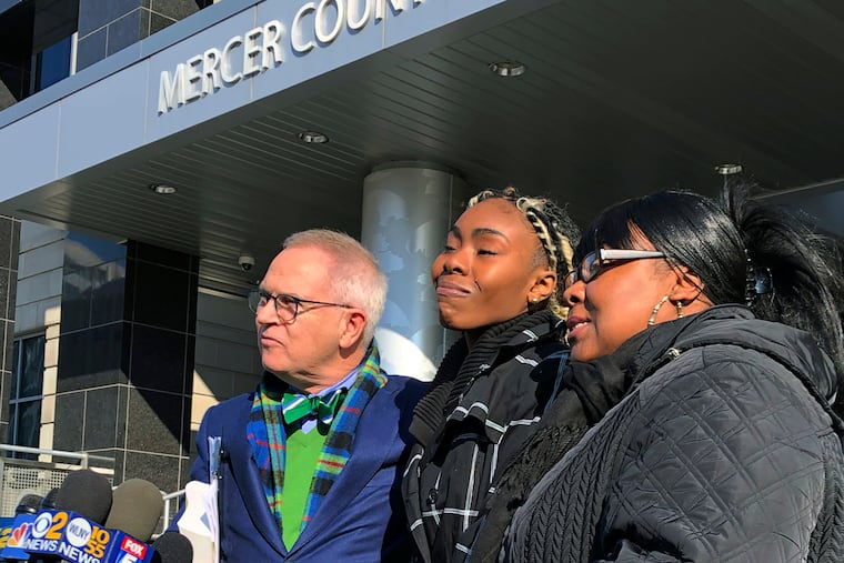FILE - In this Dec. 12, 2018, file photo, Jazmine Headley, center, joins attorney Brian Neary and her mother, Jacqueline Jenkins, outside a courthouse in Trenton, N.J., after she accepted a deal to enter a pretrial intervention program related to credit card theft charges she faced. Headley, who had her toddler yanked from her arms by New York police in a widely seen video said in an interview published on Sunday that she went into "defense mode." (AP Photo/Mike Catalini, File)