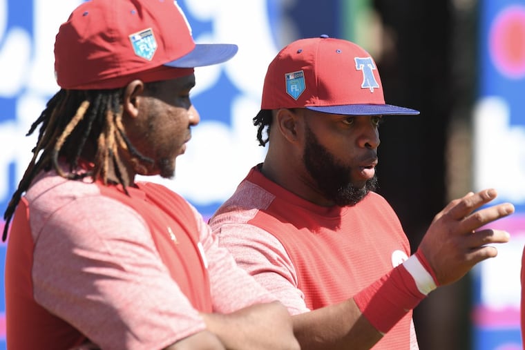 Phillies Maikel Franco, left, and Carlos Santana, interact during spring training workouts at Spectrum Field, in Clearwater Florida. Friday, Feb. 17, 2018.