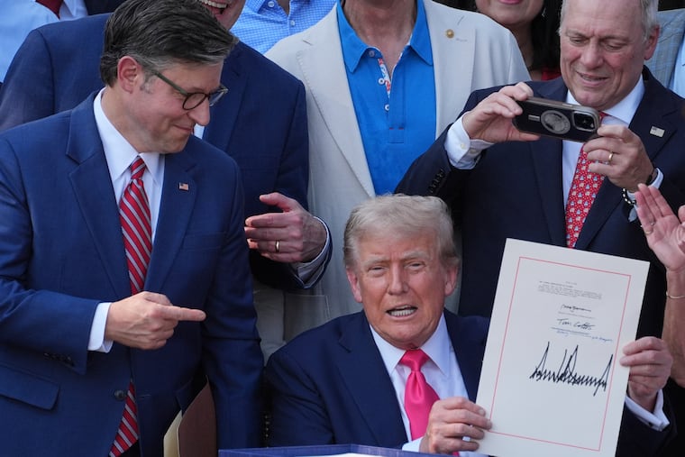 House Speaker Mike Johnson of La., points to President Donald Trump after he signed his signature bill of tax breaks and spending cuts at the White House on Friday.