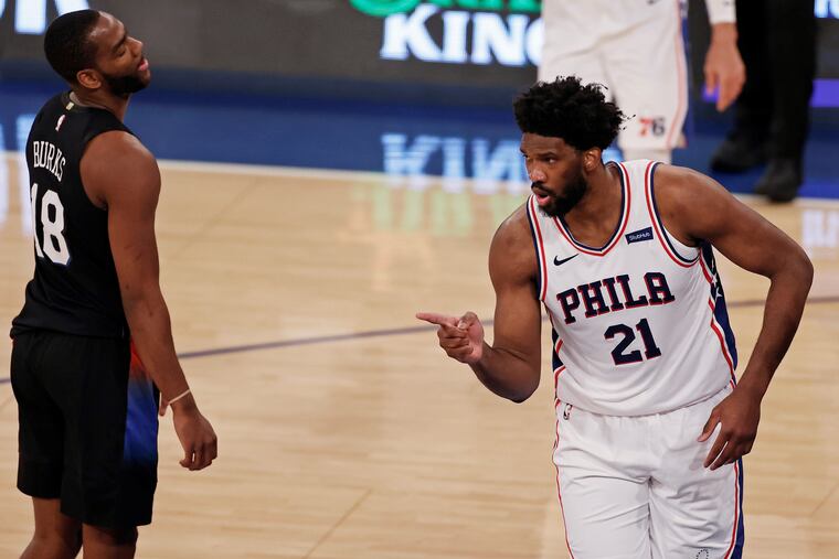 Joel Embiid (right) celebrates scoring a basket in the first half as Knicks guard and former teammate Alec Burks looks on.
