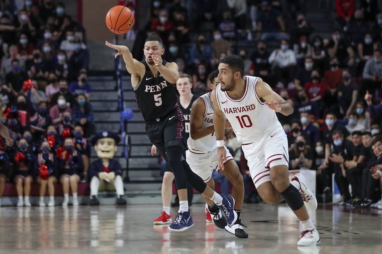 Pennsylvania Quakers guard Jelani Williams (5) passes teh ball while Harvard Crimson guard Noah Kirkwood (10) defends in the first half of a game at the Palestra in Philadelphia on Saturday, Feb. 12, 2022. Penn won, 82-74.