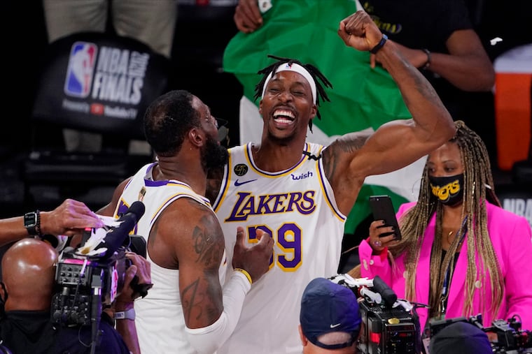 Dwight Howard (right) and LeBron James celebrate after the Lakers won the NBA Finals in October.