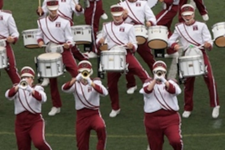 Can't rain on their parade: The Temple University Band took the field during a cloudburst. "It's really tough on the equipment. But these are hardy people, and the show will go on," an organizer said.