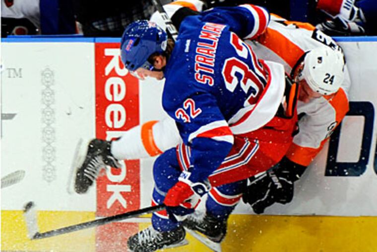 The Rangers' Anton Stralman checks Matt Read into the boards in the first period on Friday. (Henny Ray Abrams/AP)