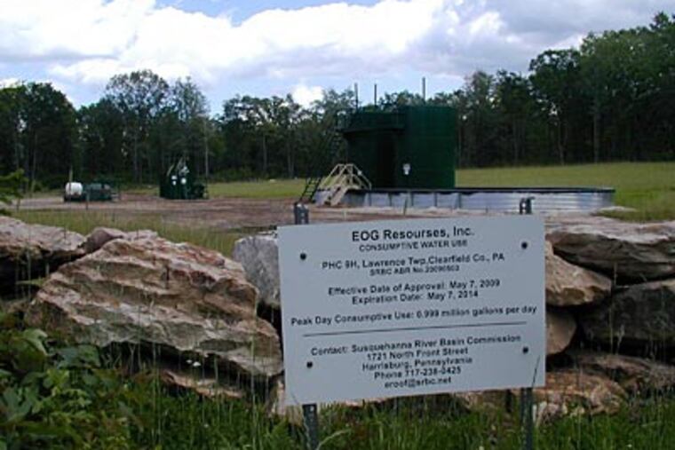 An EOG well at the Punxsutawney Hunting Club. The large containers collect liquids from the well's wastewater and fuel. (ANDY MAYKUTH / Staff)