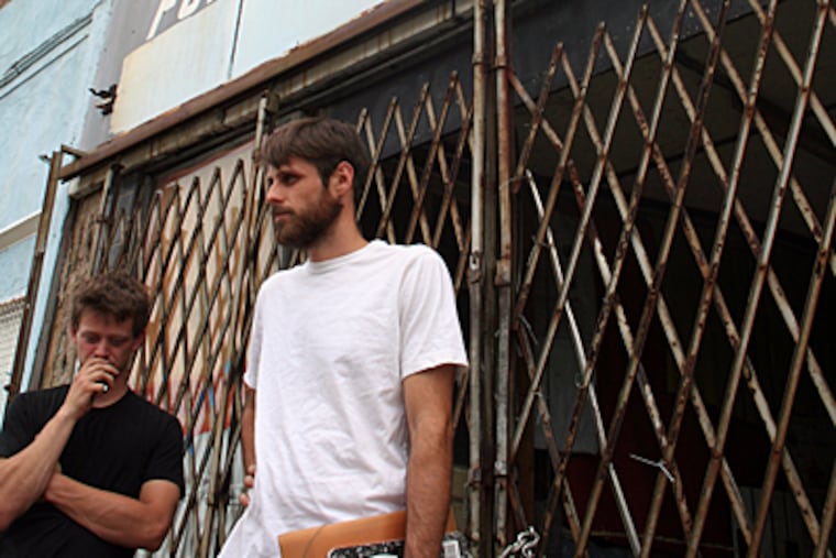 Daniel Moffat, right, and a former roommate Mitchell Troutman outside the Ridge Ave. home searched by police. (Christina Mazza / Daily News)