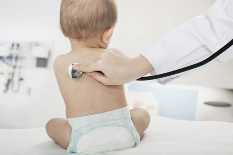 Doctor checking this baby's breathing.