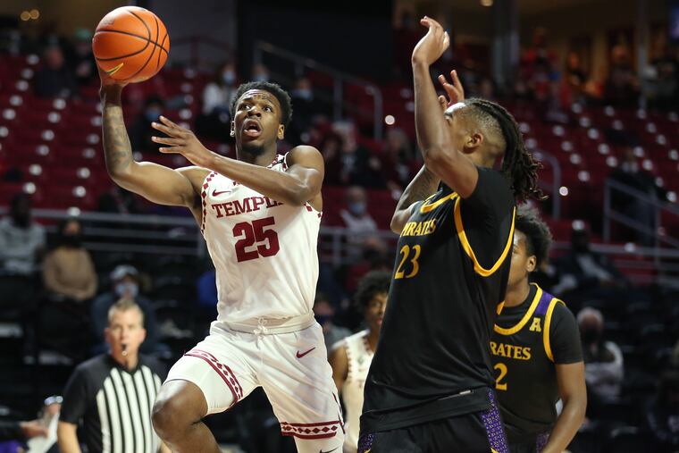 Jeremiah Williams, left, of Temple goes up for a shot over Brandon Johnson of East Carolina during the 1st half at the Liacouras Center on Jan. 8, 2022.
