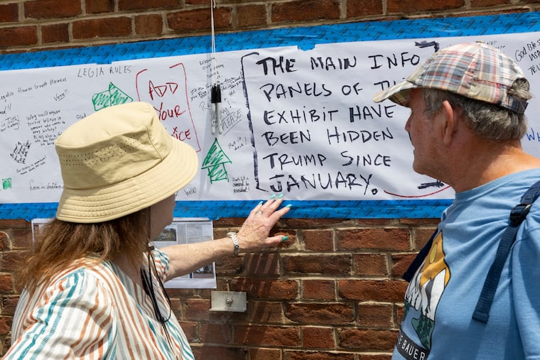 Visitors read the new signage at the President’s House in Old City on Friday, June 26, 2026. A unanimous appeals court panel recently ruled the City of Philadelphia lacks authority to control exhibits at the Independence Mall site and effectively reversed the earlier injunction back in February of this year.