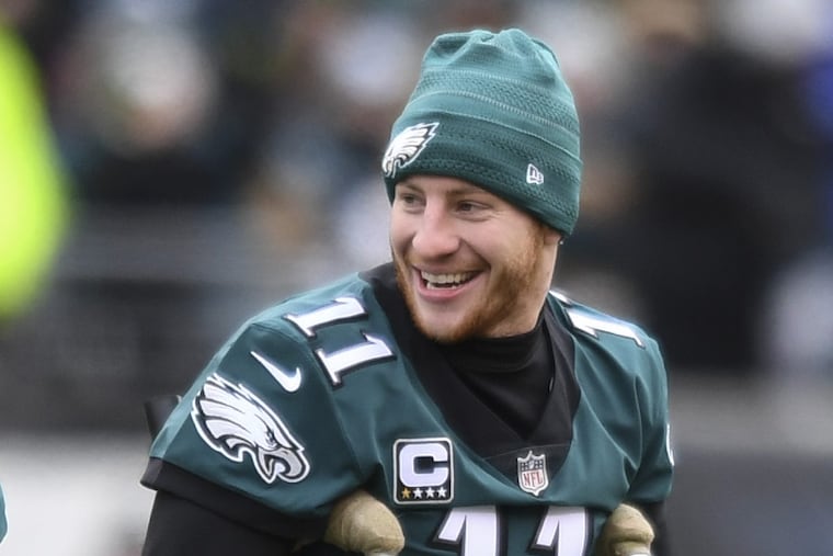 Injured Eagles quarterback Carson Wentz leaves the field after the coin toss before the team’s game against the Dallas Cowboys on Dec. 31.
