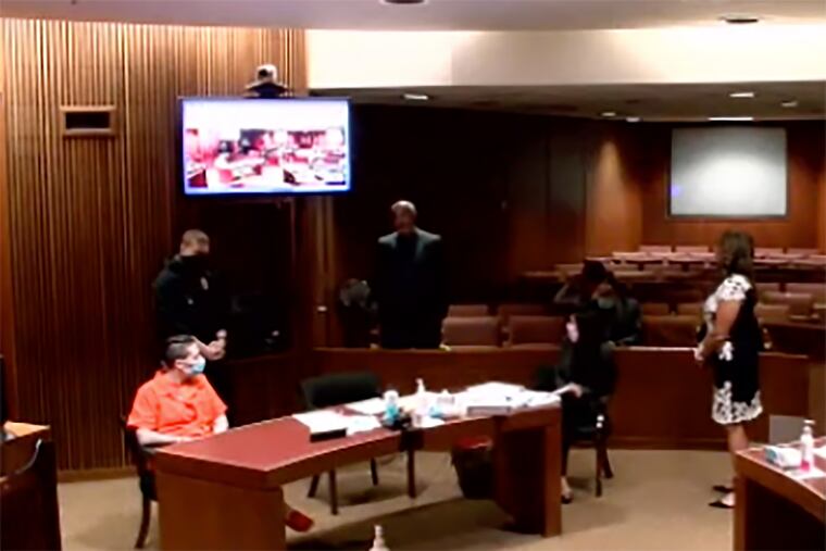 Laura Bluestein, left, listens as her father, Jason Bluestein, speaks to Burlington County Superior Court Judge Terrence Cook, on Aug. 19 during a sentencing hearing for his daughter, who was convicted of aggravated manslaughter in the 2017 fatal shooting of her wife, Felicia Dormans. The hearing was livestreamed.