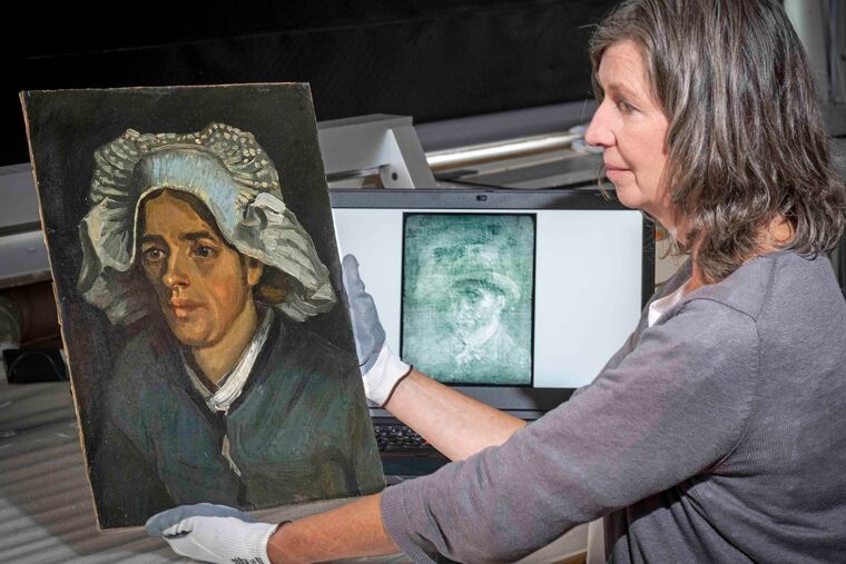 Senior Conservator Lesley Stevenson views Head of a Peasant Woman alongside an X-ray image of the hidden Van Gogh self portrait.