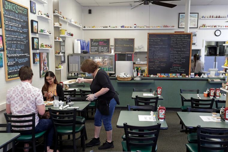 Waitress Jill Lawrence. right, waits on customers at Shakers American Cafe Monday in Orlando, Fla. Restaurants, retailers and salons are desperately trying to stay afloat as the U.S. economy reopens in fits and starts after months in a coronavirus lockdown. But billions of dollars allocated by Congress as a lifeline to those very businesses are about to be left on the table when the government's Paycheck Protection Program stops accepting applications for loans Tuesday, June 29.