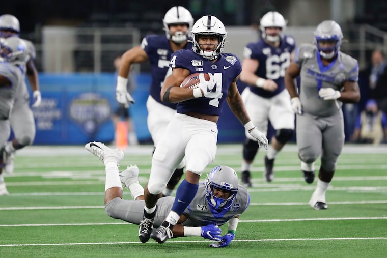 Penn State running back Journey Brown runs with the football past Memphis defensive back Quindell Johnson in the Cotton Bowl.
