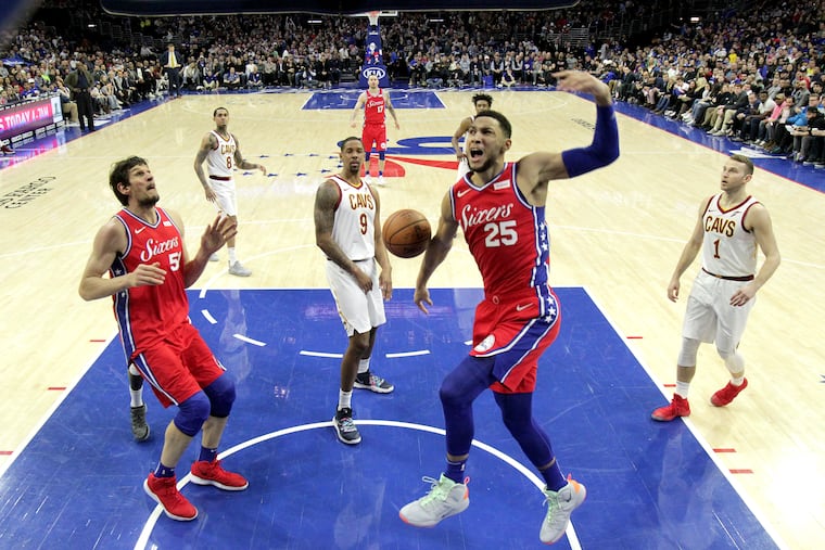 Ben Simmons (25) celebrates after dunking against the Cavaliers at Wells Fargo Center during the second half Tuesday night.