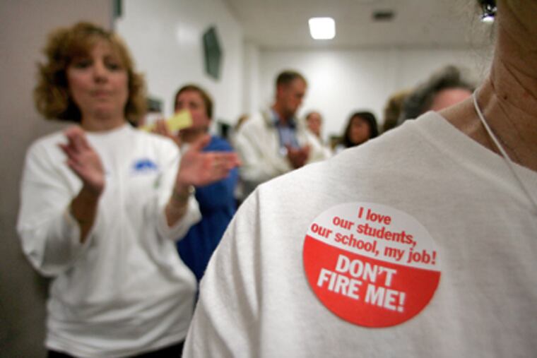 At the Winslow meeting, Joyce Bearint, a teacher for 29 years, wears a message opposing proposed layoffs. Later that night, the school board approved 160 layoffs. (David Swanson / Staff Photographer)