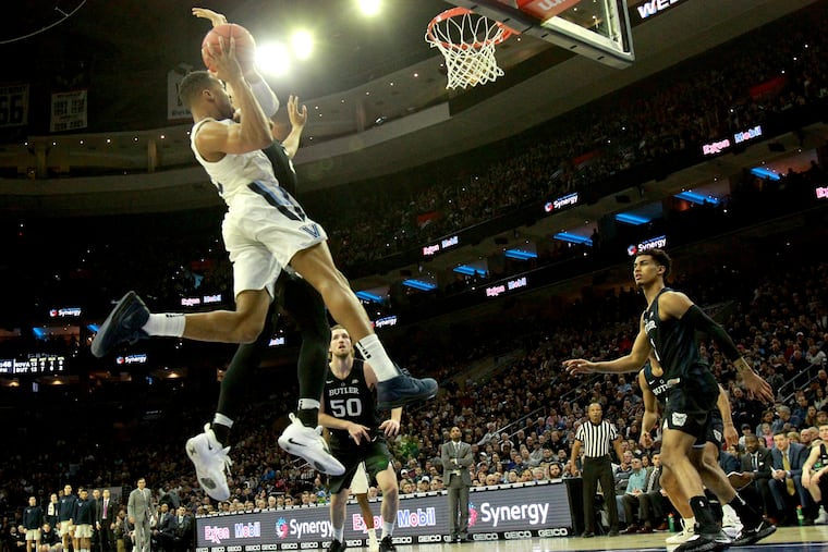 Phil Booth, left, of Villanova going up for a shot against Butler.