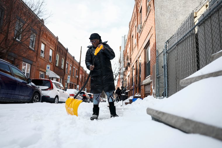 A shoveler tackles the snow and ice on Flora Street in Brewertown. Moving snow was no picnic on Monday.