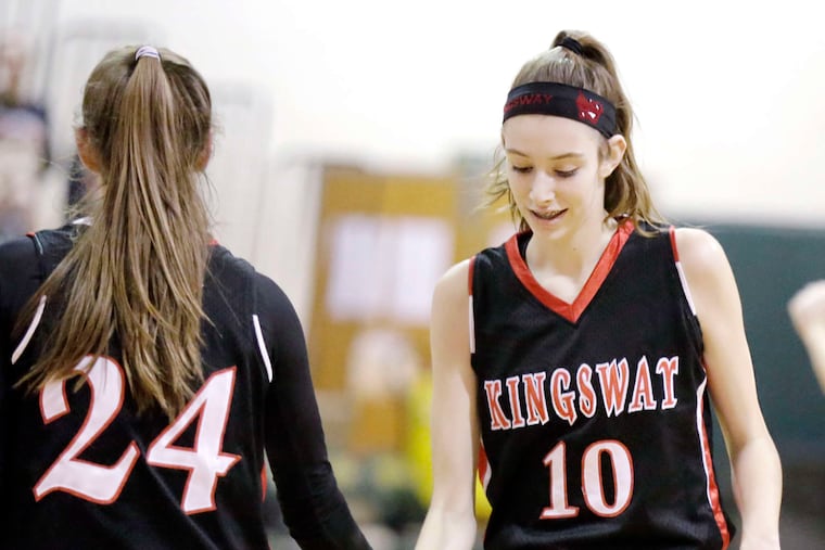 Kingsway's Maddie Hahn (right) gets a low-five from sister Zoe during a game. Maddie is a 6-foot-2 junior, Zoe a 6-foot senior. Though they're generally the tallest players on the court, they are both skilled ballhandlers, driving to the net like guards.