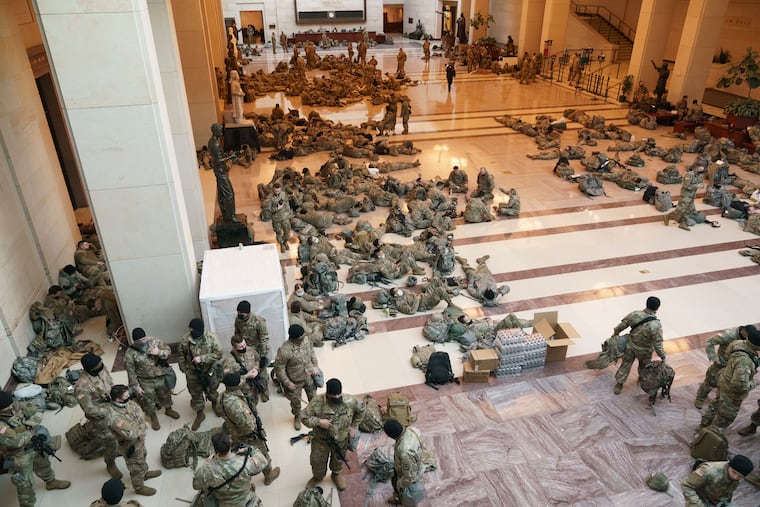 Hundreds of National Guard troops wait inside the Capitol Visitor's Center to reinforce security at the Capitol in Washington.