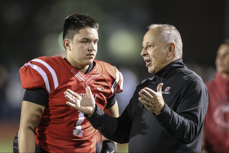 Coatesville offensive coordinator Jim Cantafio talks with junior quarterback Ricky Ortega (1) near the end of a 42-14 win over Downingtown West.