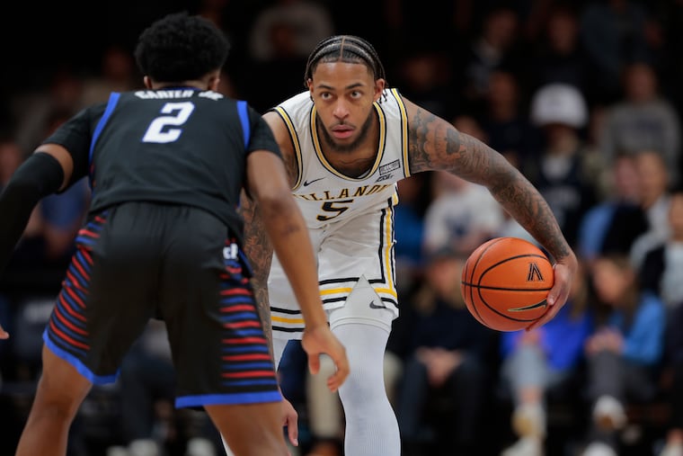 Vilanova's Justin Moore is guarded by Chico Carter of DePaul on Jan. 12. The Wildcats have lost four straight.