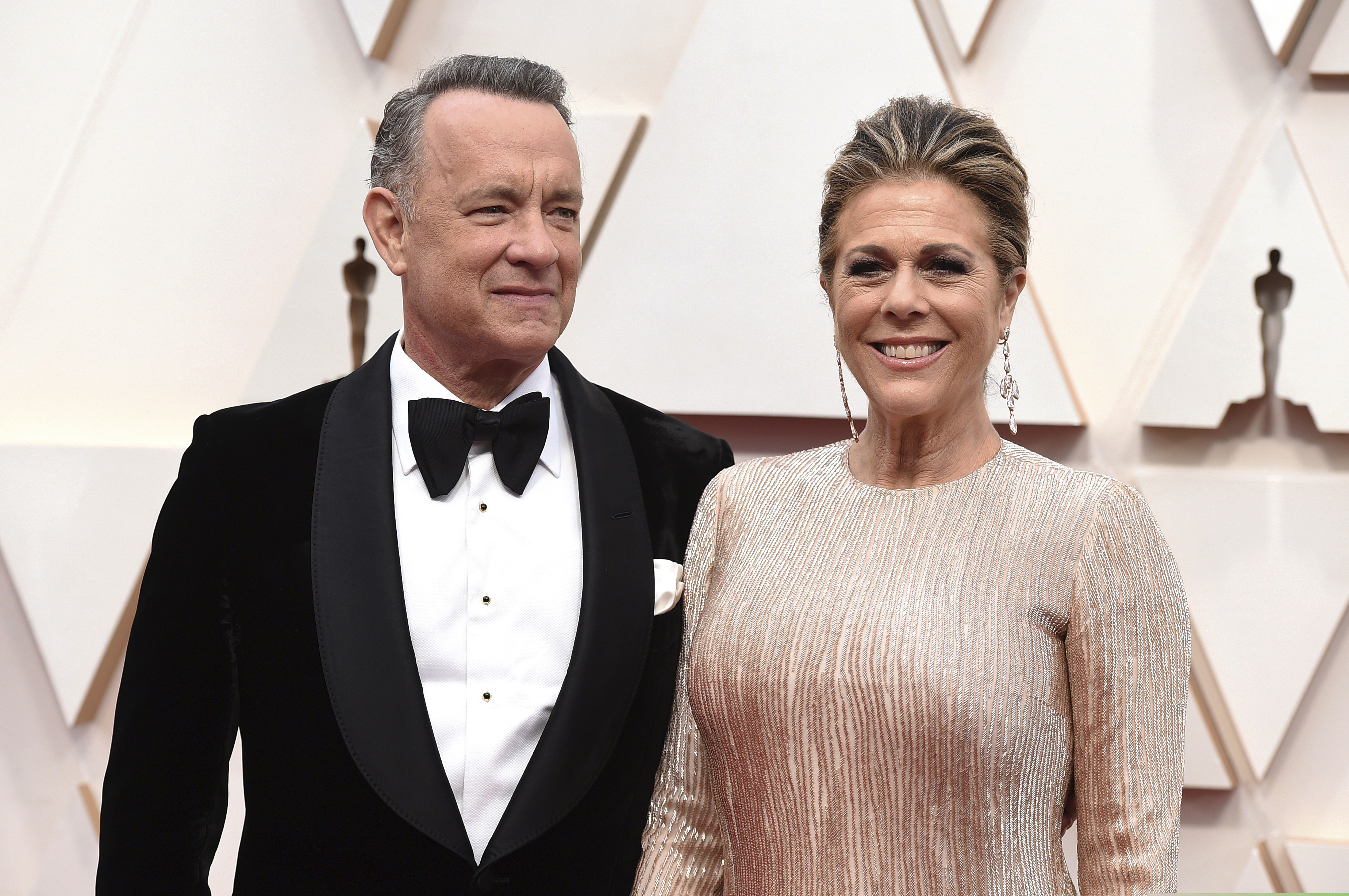 Tom Hanks and Rita Wilson arrive at the Oscars at the Dolby Theatre in Los Angeles. The couple have tested positive for the coronavirus, the actor said in a statement Wednesday.