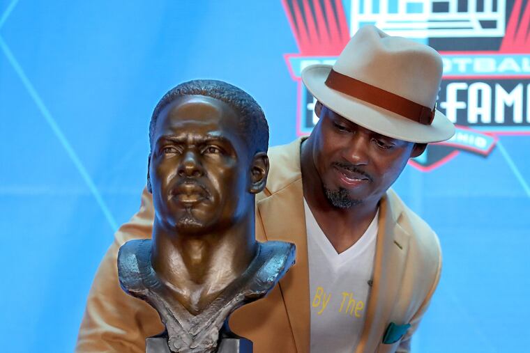 Brian Dawkins looks over his Hall of Fame bust at the enshrinement ceremony on Aug. 4.