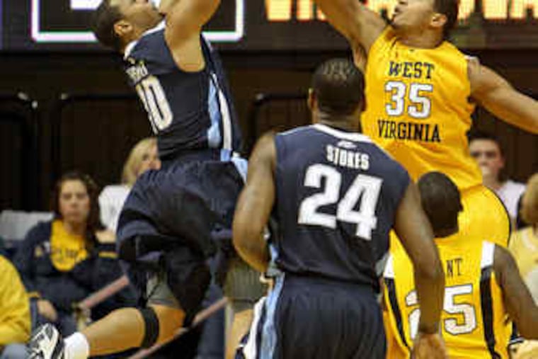 Villanova's Corey Fisher , who had 17 points, puts up a shot in the second half as West Virginia's Wellington Smith defends.