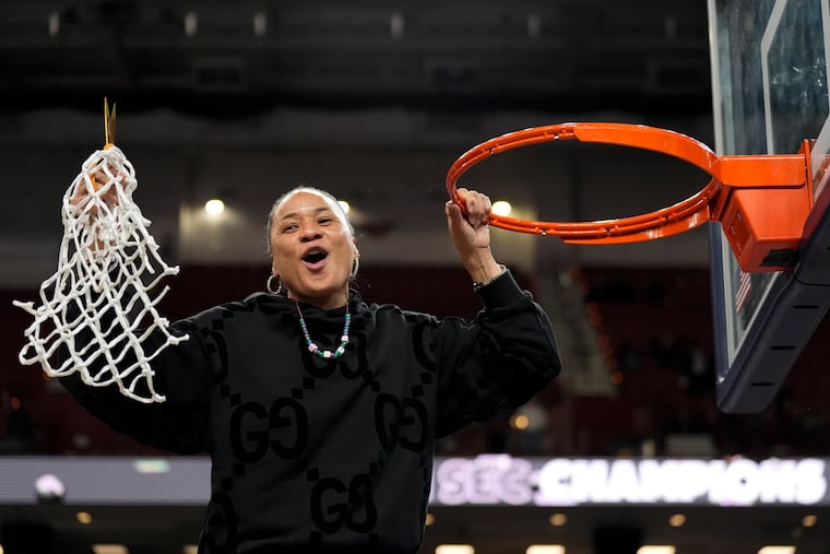 South Carolina coach Dawn Staley celebrates cutting down the net after the win against LSU in the SEC women's tournament final on Sunday in Greenville, S.C.