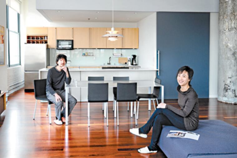 Cheng Leng (left) and Alice Sun in the Great Room/Dining Room/Kitchen of their center city condo. ( Clem Murray / Staff Photographer )