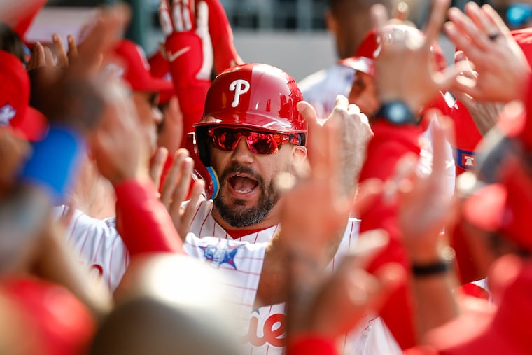 Kyle Schwarber celebrates in the Phillies dugout after he hit a two-run home run in the first inning against the Rangers.