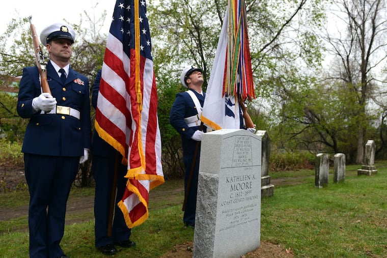 A Coast Guard Color Guard at the headstone for Kathleen Moore, who died in 1899.