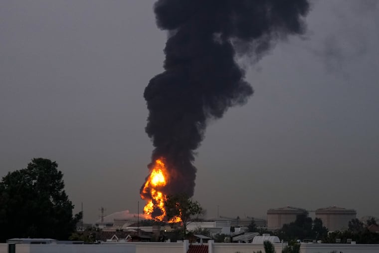 Fire and plumes of smoke rises after s drone struck a fuel tank forcing the temporary suspension of flights. near Dubai International Airport, in United Arab Emirates, early Monday, March 16, 2026.