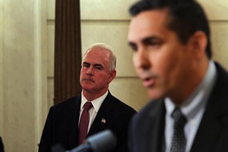 Pat Meehan watches as his opponent, Bryan Lentz, rebuts allegations made by Meehan minutes earlier from the same podium. (Laurence Kesterson / Staff Photographer)
