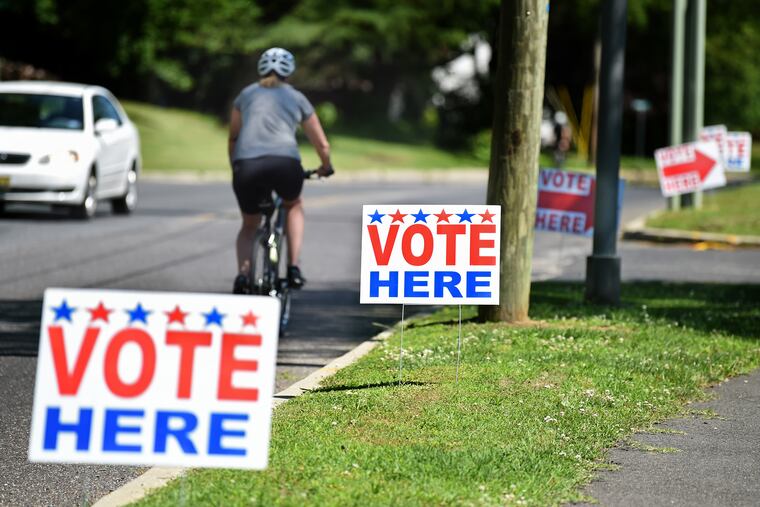 Signs outside the polling place in the Camden County Parks Department headquarters in Cherry Hill in June.