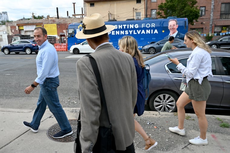Republican Jeff Bartos' bus stops at Philadelphia’s Italian Market, where his family joined him. At right are his two daughters, Emily, 20; and Sarah (partially hidden), 18.