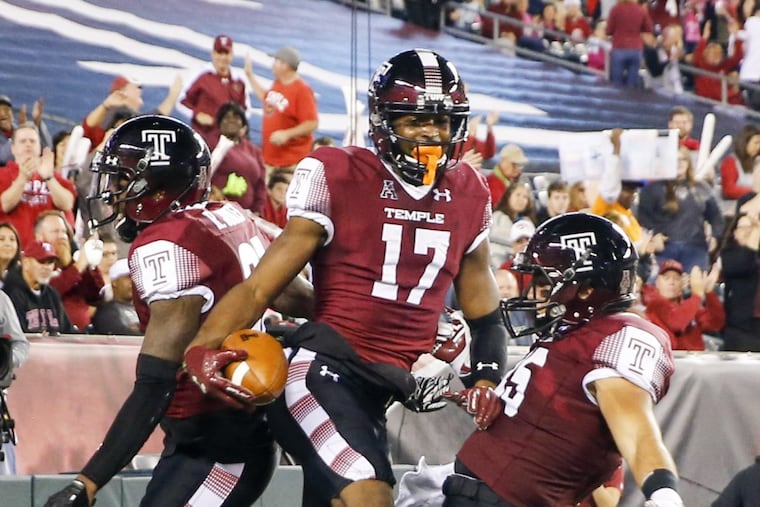 Temple wide receiver Adonis Jennings, center, celebrates his first-quarter touchdown reception against Navy with wide receiver Randle Jones, left, and fullback Rob Ritrovato during an NCAA college football game Thursday, Nov. 2, 2017, in Philadelphia. (Yong Kim/The Philadelphia Inquirer via AP)