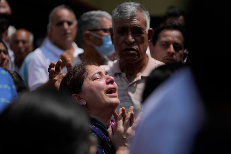 A relative mourns at the funeral of Raj Thapa, a senior bureaucrat who was killed in Pakistani shelling in Rajouri, in Jammu, India, Sunday, May 11, 2025. (AP Photo/Channi Anand)