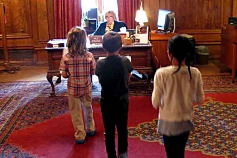File photo: Children deliver letters written by Philadelphia public school students to the office of Gov. Tom Corbett on Wednesday, June 12, 2013, in Harrisburg, Pa. (AP Photo/Marc Levy)