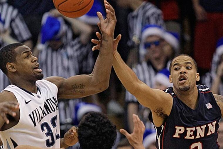 Villanova's James Bell and Penn's Henry Brooks and Tony Bagtas go after a rebound. (Laurence Kesterson/AP)