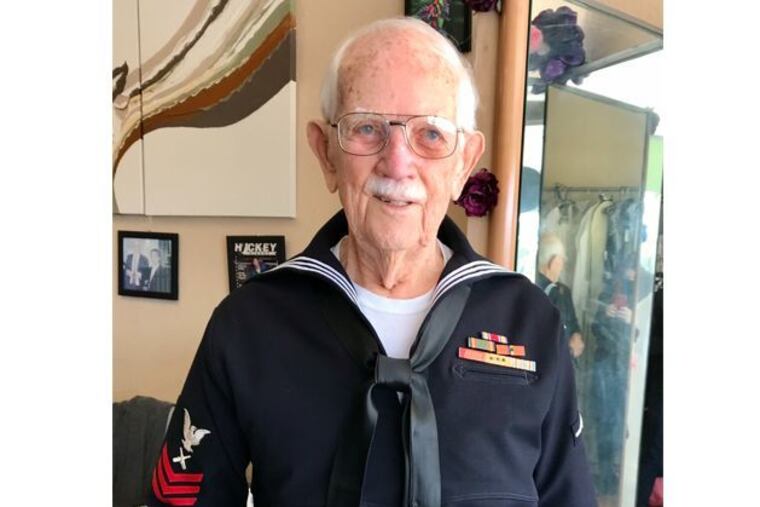 Joe Hall trying on his new uniform at Causeway Alterations this year.