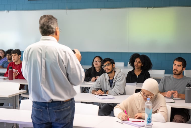 Temple University biology professor Jody Hey teaches a class; no laptops or iPhones are allowed. Students must take notes by hand.