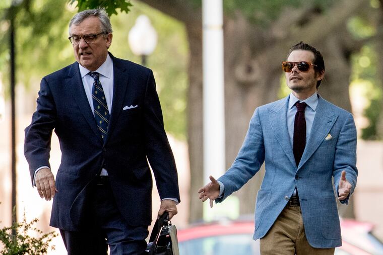 Andrew Miller, a witness who fought testifying to the grand jury in the Roger Stone part of the Russia investigation, right, arrives with his attorney Paul Kamenar, left, at federal court in Washington, Friday, May 31, 2019.