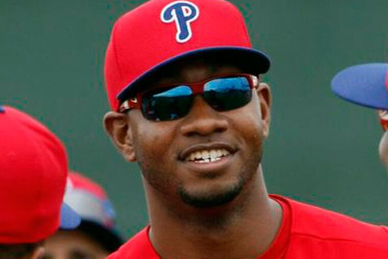 Domonic Brown (center) stands next to teammates Ryan Howard and Zach Collier during spring training in Clearwater, FL on Thursday, February 14, 2013. (Yong Kim/Staff Photographer)