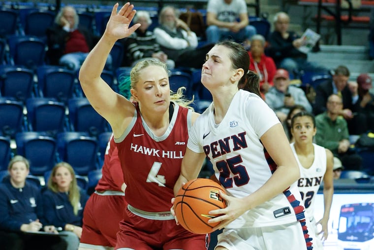 Penn's Katie Collins drives on St. Joseph's Laura Ziegler on Nov. 15 at the Palestra.