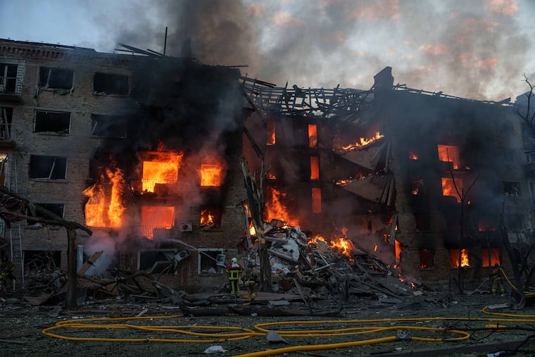 Rescue workers try to put out a fire at a residential building after a Russian strike on Kyiv, Ukraine, Sunday, May 24, 2026.