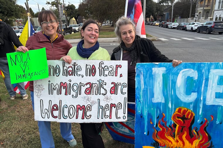 Activists with the group Indivisible NOLA protest against federal immigration raids in New Orleans at the intersection of Elysian Fields and St. Claude Avenues on Wednesday.