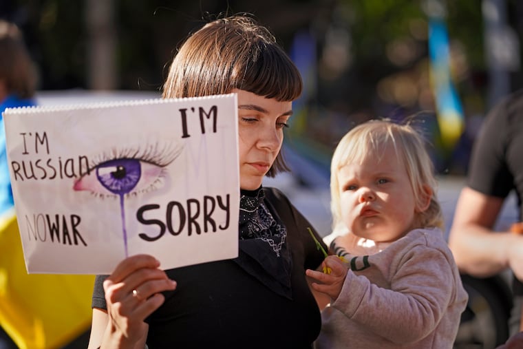 Russina citizen Katrina Repina holds her infant daughter, Zoe, in one hand and a sign in the other that reads: "I'm Russian, No War. I'm sorry," to express her support to Ukraine in Santa Monica's Third Street Promenade in Santa Monica, Calif., Sunday, Feb. 27, 2022. "I don't support Putin," she said. "My heart bleeds when I see all the news. I feel the Ukrainian people's pain and I wish I can take that pain away." Repina came to the protest with her Ukrainian friend, Hanna Husakova. They connected on Instagram and bonded over their common language and culture. (AP Photo/Damian Dovarganes)