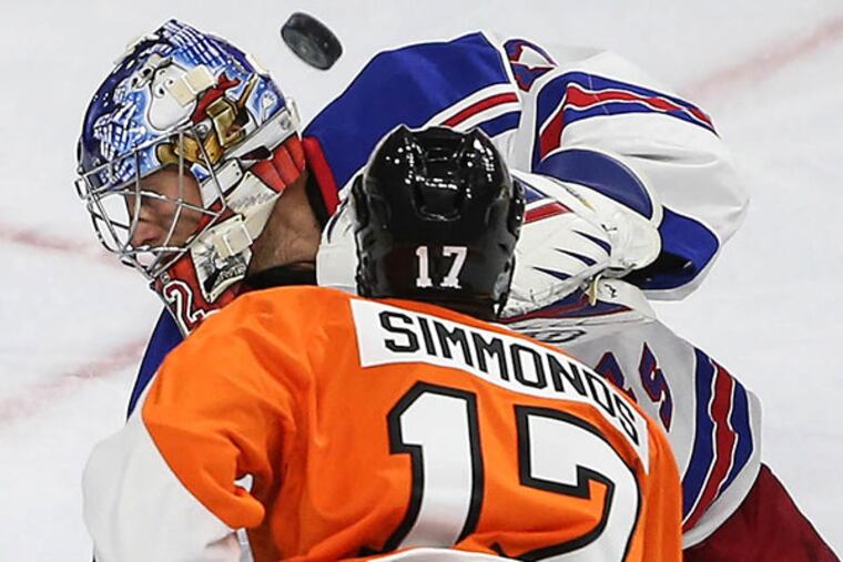 The Flyers' Wayne Simmonds watches the puck sail over the head of Rangers' goalie Antti Raanta during the third period.